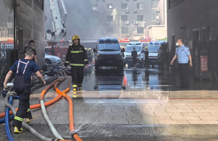 Firefighters try to extinguish flames and reach those trapped inside a shoe factory that caught fire in Jinjiang.
