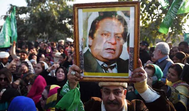 A man holding Nawaz Sharif picture in 2018/ File Photo