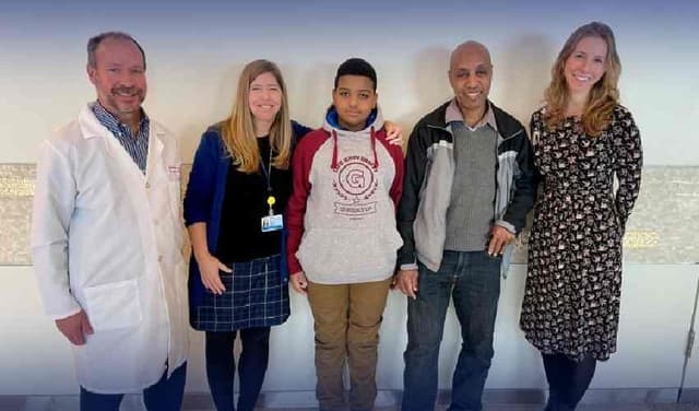 Aissam Dam, third from left, was born 'profoundly deaf' because of a highly rare abnormality in a single gene Handout