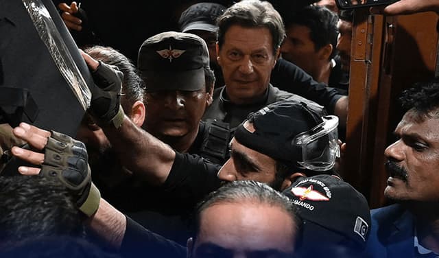 Imran Khan, Pakistan's former prime minister, leaves after appearing in court for protective bail in two charges in Lahore on March 21, 2023.
