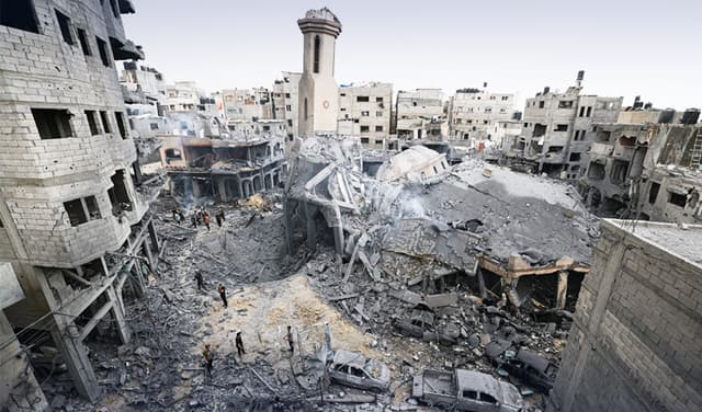 Palestinians inspect the destruction around a mosque levelled by Israeli airstrikes in Gaza City. Photo: AFP