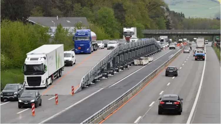 Mobile bridges made it possible for workers to pave roads without stopping traffic